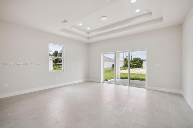 4873/4875 29th St SW, Lehigh Acres, FL 33973 - empty room with plenty of natural light, a raised ceiling, recessed lighting, and light tile patterned floors