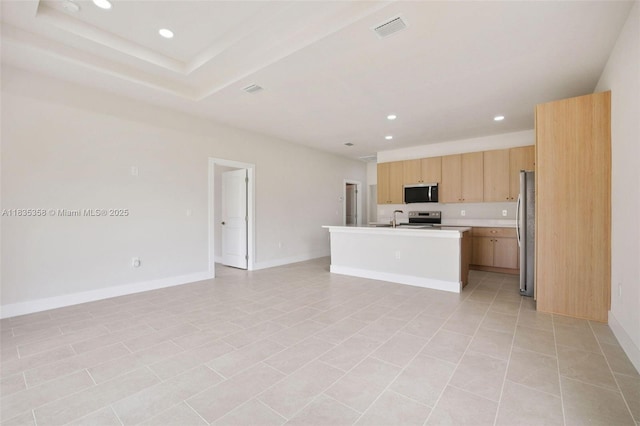 4873/4875 29th St SW, Lehigh Acres, FL 33973 - kitchen featuring appliances with stainless steel finishes, open floor plan, recessed lighting, an island with sink, and light countertops