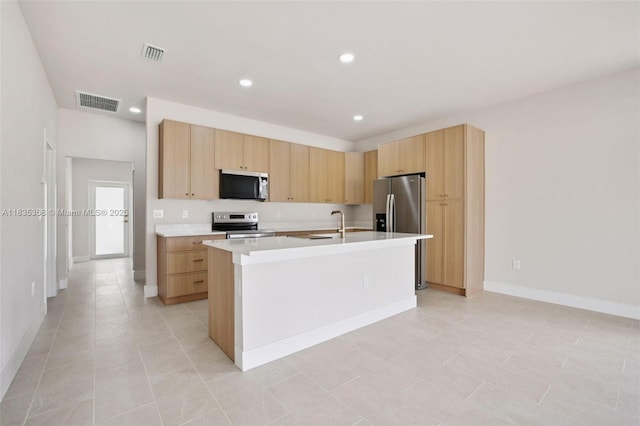4873/4875 29th St SW, Lehigh Acres, FL 33973 - kitchen featuring stainless steel appliances, light brown cabinetry, light countertops, a center island with sink, and recessed lighting
