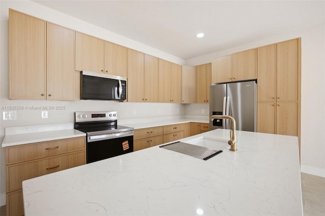 4873/4875 29th St SW, Lehigh Acres, FL 33973 - kitchen with stainless steel appliances, light brown cabinets, light stone countertops, and recessed lighting