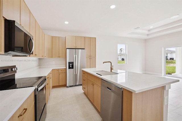 4873/4875 29th St SW, Lehigh Acres, FL 33973 - kitchen featuring stainless steel appliances, light brown cabinets, recessed lighting, a center island with sink, and light stone counters