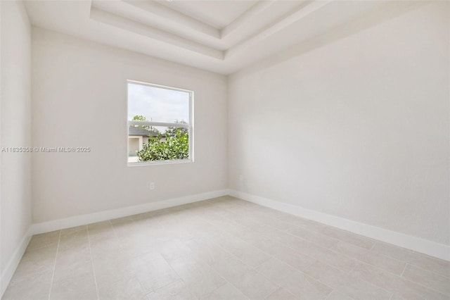 4873/4875 29th St SW, Lehigh Acres, FL 33973 - empty room featuring a tray ceiling and baseboards