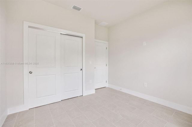 4873/4875 29th St SW, Lehigh Acres, FL 33973 - unfurnished bedroom featuring a closet and baseboards