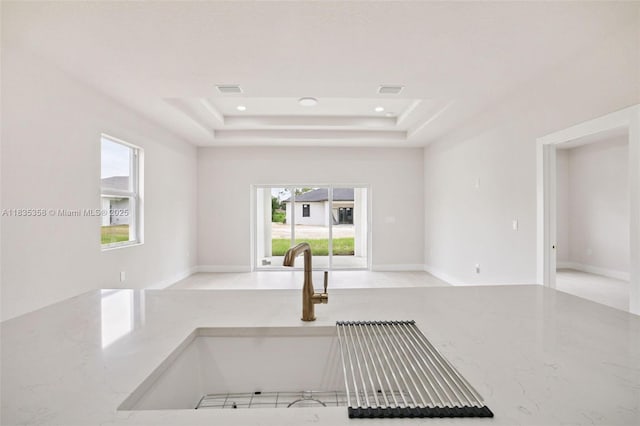 4873/4875 29th St SW, Lehigh Acres, FL 33973 - kitchen with plenty of natural light, a raised ceiling, light stone counters, open floor plan, and recessed lighting