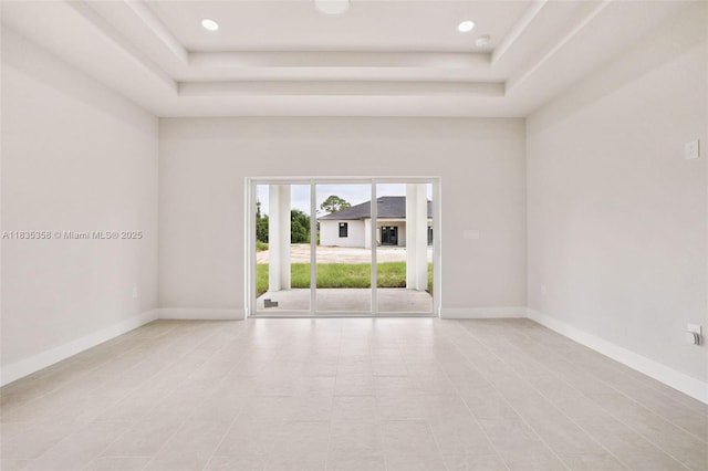 4873/4875 29th St SW, Lehigh Acres, FL 33973 - unfurnished room with a tray ceiling, light tile patterned floors, and recessed lighting