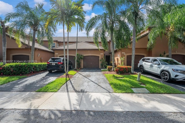 1528 Veracruz Ln Unit 4-3, Weston, FL 33327 - view of front of home featuring stucco siding, asphalt driveway, an attached garage, and a tiled roof