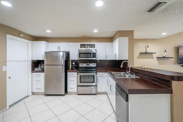 1528 Veracruz Ln Unit 4-3, Weston, FL 33327 - kitchen with appliances with stainless steel finishes, dark countertops, recessed lighting, backsplash, and a textured ceiling