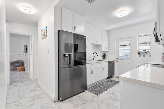 1100 NW 151st St, Miami, FL 33169 - kitchen with stainless steel appliances, light marble finish floors, light countertops, and white cabinets