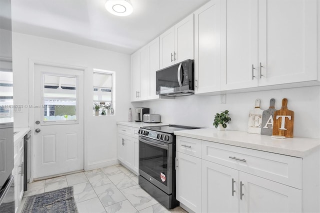 1100 NW 151st St, Miami, FL 33169 - kitchen featuring black microwave, electric stove, light marble finish flooring, light countertops, and white cabinetry