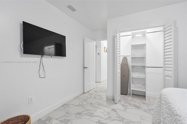 1100 NW 151st St, Miami, FL 33169 - bedroom with marble look tiles and a closet