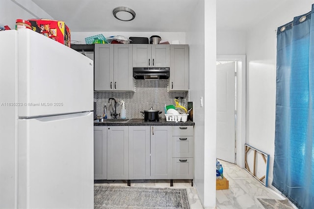 1100 NW 151st St, Miami, FL 33169 - kitchen with freestanding refrigerator, range hood, light marble finish flooring, decorative backsplash, and dark countertops
