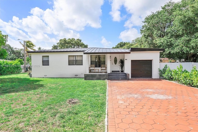 1100 NW 151st St, Miami, FL 33169 - view of front of house featuring a garage, stucco siding, a porch, decorative driveway, and a standing seam roof