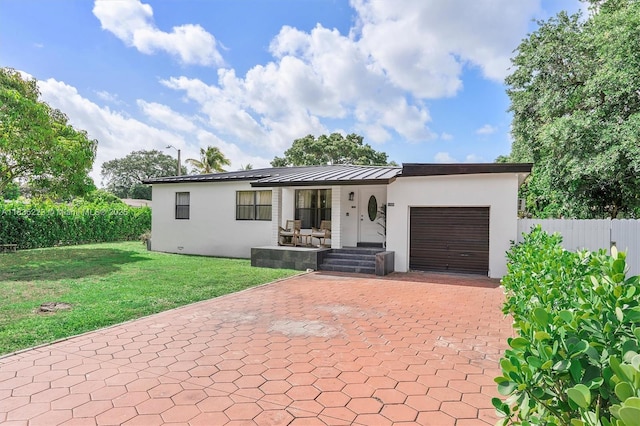 1100 NW 151st St, Miami, FL 33169 - view of front of house featuring stucco siding, decorative driveway, a garage, and a porch