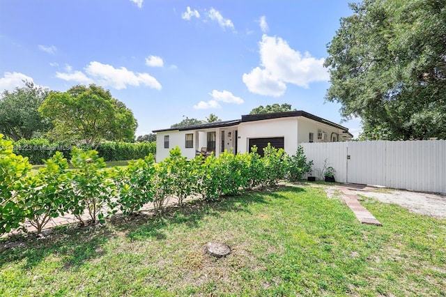 1100 NW 151st St, Miami, FL 33169 - rear view of house with stucco siding and an attached garage