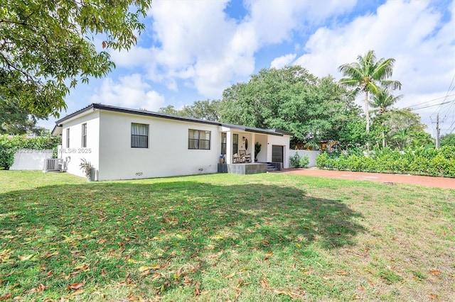 1100 NW 151st St, Miami, FL 33169 - back of property with an attached garage, stucco siding, concrete driveway, and a patio area