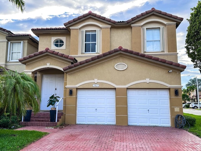 7427 NW 113th Path, Doral, FL 33178 - view of property featuring decorative driveway, an attached garage, a tile roof, and stucco siding