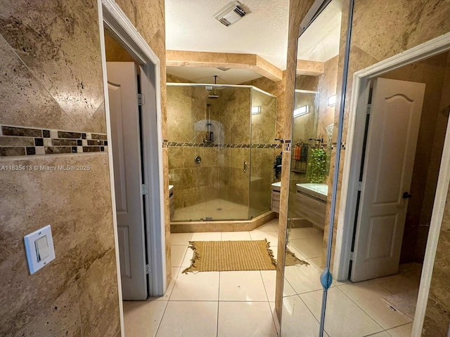 7427 NW 113th Path, Doral, FL 33178 - bathroom with tile patterned flooring, a stall shower, vanity, and tile walls