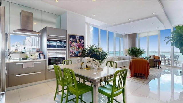 2020 N Bayshore Dr Unit 2801, Miami, FL 33137 - dining area featuring light tile patterned floors, recessed lighting, a water view, and expansive windows