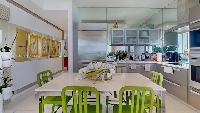 2020 N Bayshore Dr Unit 2801, Miami, FL 33137 - kitchen featuring stainless steel appliances, light tile patterned floors, modern cabinets, and light countertops