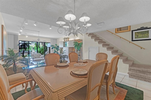 1426 NE 105th St Unit D9, Miami Shores, FL 33138 - dining space with stairway, tile patterned flooring, a textured ceiling, and a chandelier