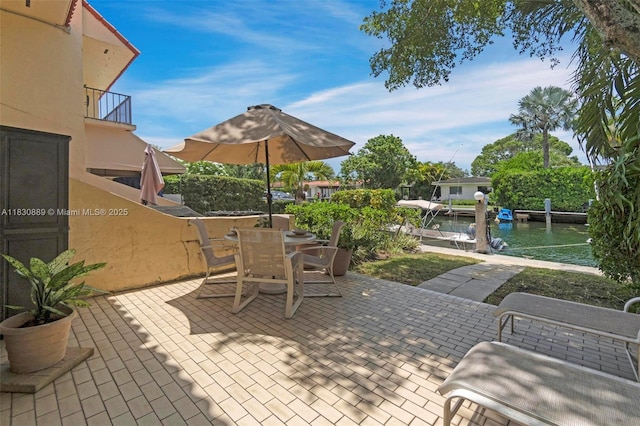1426 NE 105th St Unit D9, Miami Shores, FL 33138 - patio / terrace featuring a patio area, a boat dock, a water view, and outdoor dining space