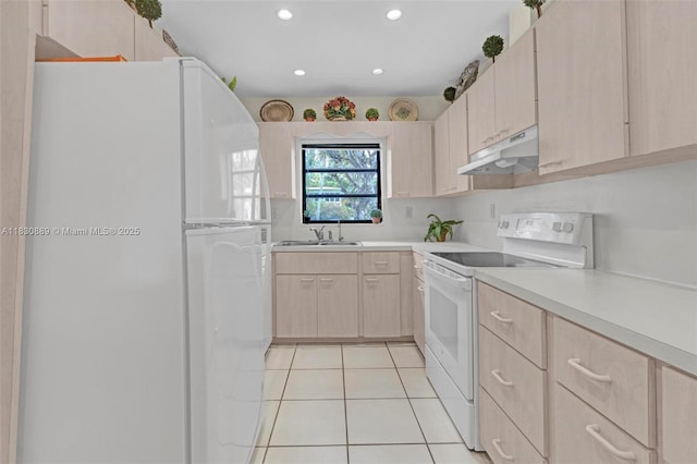 1426 NE 105th St Unit D9, Miami Shores, FL 33138 - kitchen featuring white appliances, under cabinet range hood, light brown cabinetry, light countertops, and recessed lighting