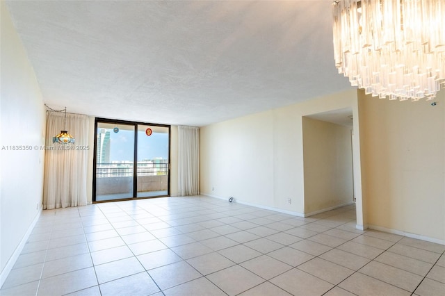 2500 Parkview Dr Unit 1502, Hallandale Beach, FL 33009 - unfurnished room with light tile patterned floors, a wall of windows, and a chandelier