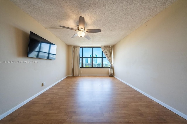 2500 Parkview Dr Unit 1502, Hallandale Beach, FL 33009 - empty room featuring a textured ceiling, ceiling fan, and wood finished floors