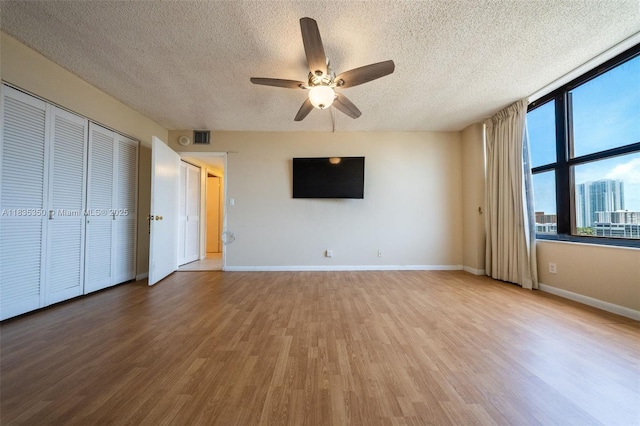 2500 Parkview Dr Unit 1502, Hallandale Beach, FL 33009 - unfurnished living room with a textured ceiling, a ceiling fan, and light wood-style floors