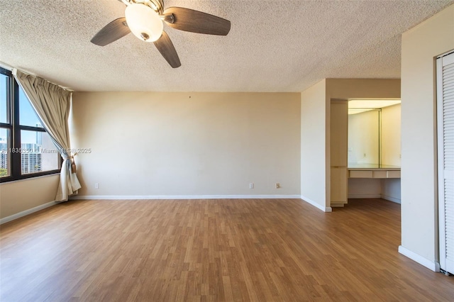 2500 Parkview Dr Unit 1502, Hallandale Beach, FL 33009 - spare room featuring wood finished floors, a textured ceiling, ceiling fan, and a desk
