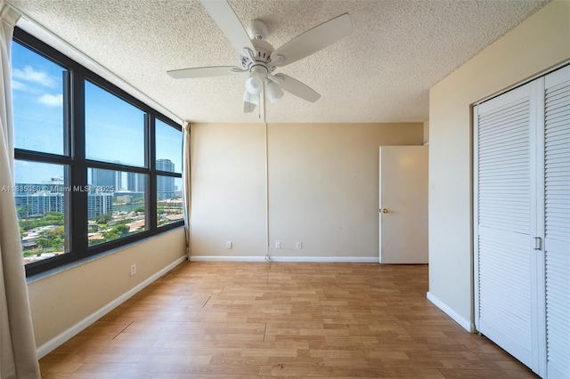 2500 Parkview Dr Unit 1502, Hallandale Beach, FL 33009 - unfurnished bedroom featuring a textured ceiling, light wood-style floors, a ceiling fan, and a closet