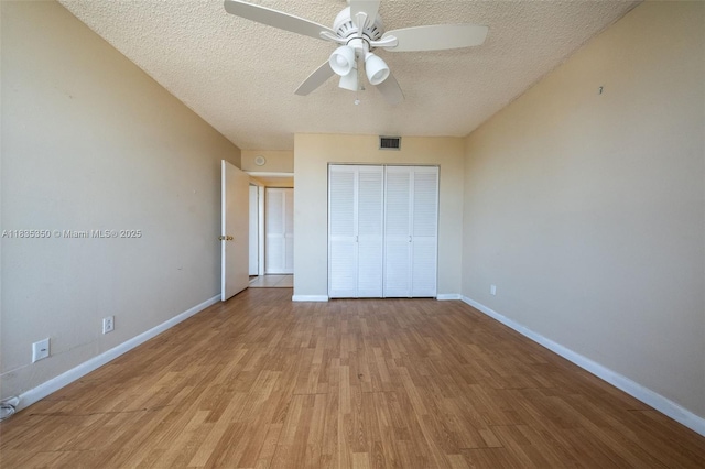 2500 Parkview Dr Unit 1502, Hallandale Beach, FL 33009 - unfurnished bedroom featuring a textured ceiling, wood finished floors, a closet, and a ceiling fan