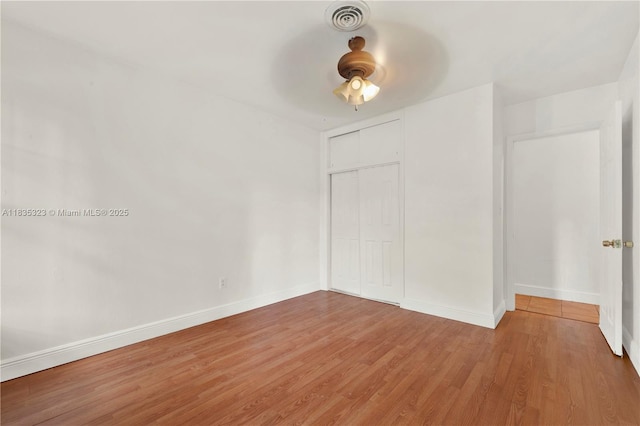 15831 Palmetto Club Dr, Miami, FL 33157 - unfurnished bedroom featuring wood finished floors, a closet, and a ceiling fan