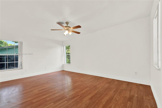 15831 Palmetto Club Dr, Miami, FL 33157 - empty room featuring plenty of natural light, wood finished floors, and a ceiling fan