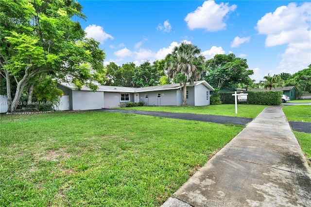 15831 Palmetto Club Dr, Miami, FL 33157 - view of front of property with a front yard, stucco siding, and driveway