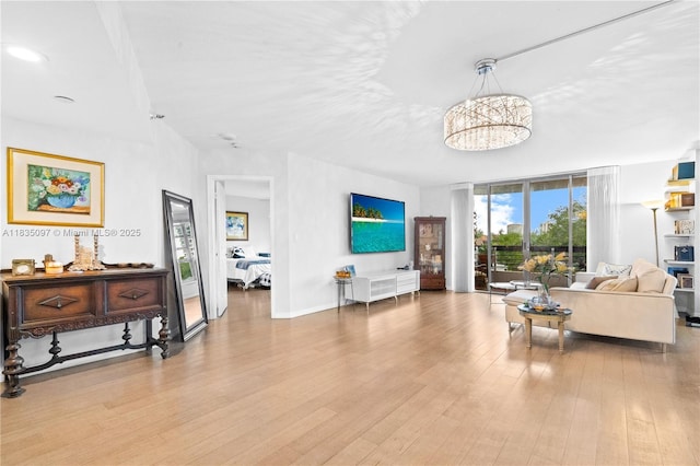 3530 Mystic Pointe Dr Unit 309, Aventura, FL 33180 - living room with wood finished floors and a chandelier