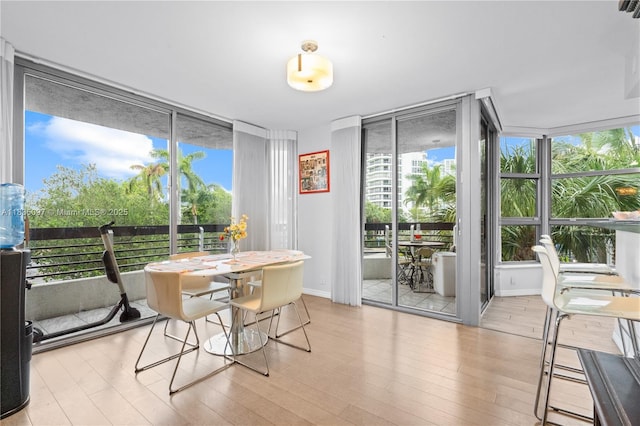 3530 Mystic Pointe Dr Unit 309, Aventura, FL 33180 - dining room with expansive windows and wood finished floors