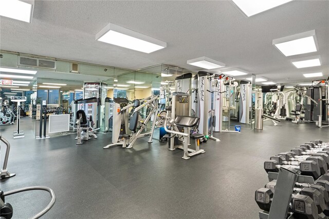 3530 Mystic Pointe Dr Unit 309, Aventura, FL 33180 - workout area with a textured ceiling