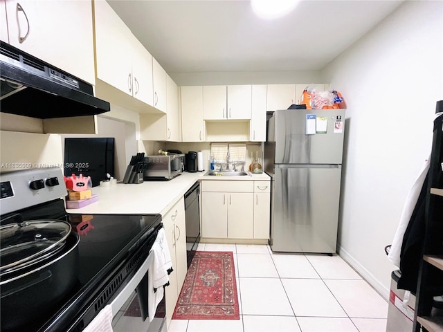 9974 SW 88th St Unit 1033, Miami, FL 33176 - kitchen with stainless steel appliances, ventilation hood, light countertops, and white cabinetry