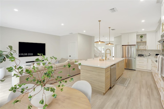14751 SW 23rd St Unit 14751, Miami, FL 33185 - kitchen with appliances with stainless steel finishes, open shelves, backsplash, a center island with sink, and light countertops