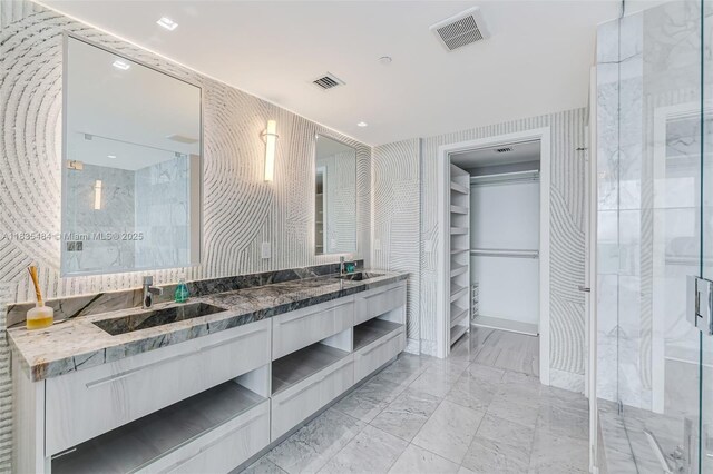 3131 NE 7th Ave Unit 4001, Miami, FL 33137 - bathroom featuring double vanity, a marble finish shower, a walk in closet, and marble finish flooring