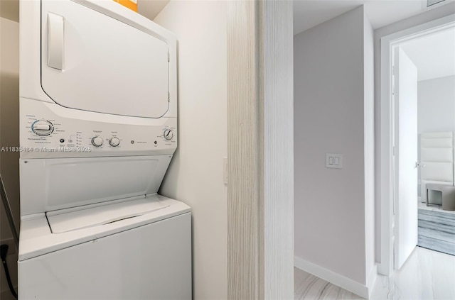 3131 NE 7th Ave Unit 4001, Miami, FL 33137 - washroom with stacked washer and clothes dryer and baseboards