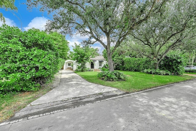 135 NE 87th St, El Portal, FL 33138 - obstructed view of property featuring a front lawn and driveway