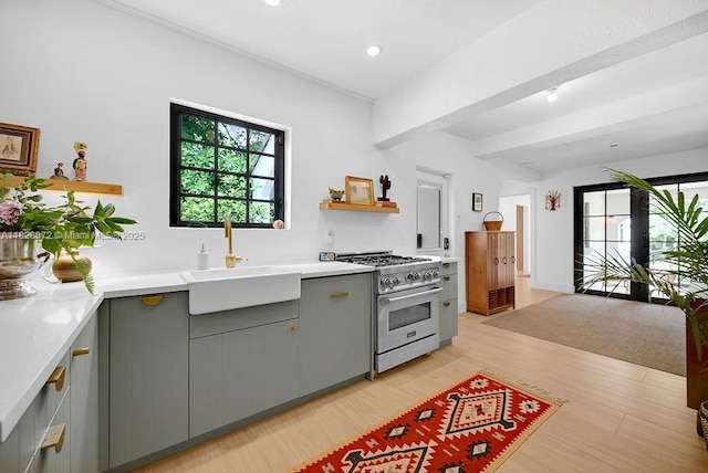 135 NE 87th St, El Portal, FL 33138 - kitchen featuring stainless steel stove, gray cabinetry, light wood-style floors, light countertops, and recessed lighting