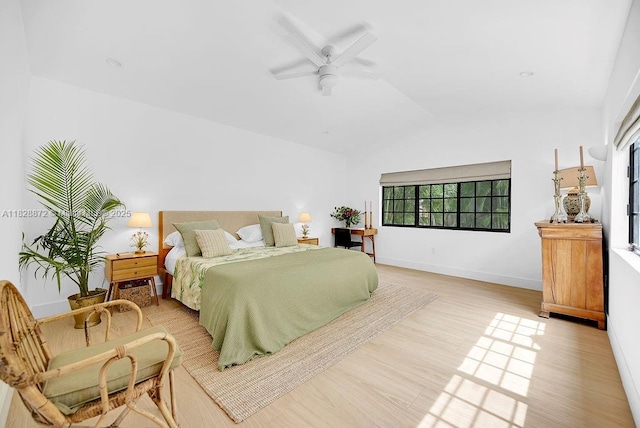135 NE 87th St, El Portal, FL 33138 - bedroom with light wood finished floors, vaulted ceiling, and a ceiling fan