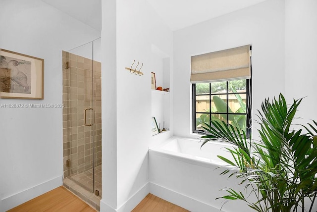 135 NE 87th St, El Portal, FL 33138 - full bath with a shower stall, wood finished floors, and a garden tub