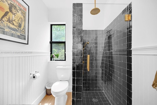 135 NE 87th St, El Portal, FL 33138 - full bath with tiled shower, a wainscoted wall, and wood finished floors