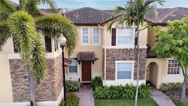 9323 SW 227th St Unit 2-5, Cutler Bay, FL 33190 - view of front of house with stucco siding, stone siding, and a tile roof