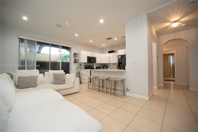 9323 SW 227th St Unit 2-5, Cutler Bay, FL 33190 - living room with arched walkways, light tile patterned floors, and recessed lighting