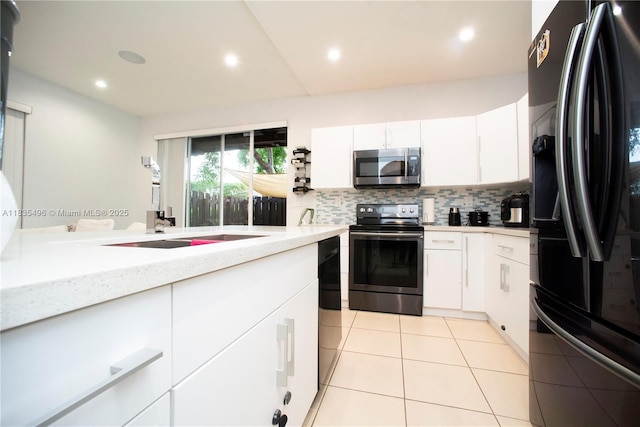 9323 SW 227th St Unit 2-5, Cutler Bay, FL 33190 - kitchen with freestanding refrigerator, stainless steel microwave, electric range, tasteful backsplash, and light tile patterned floors